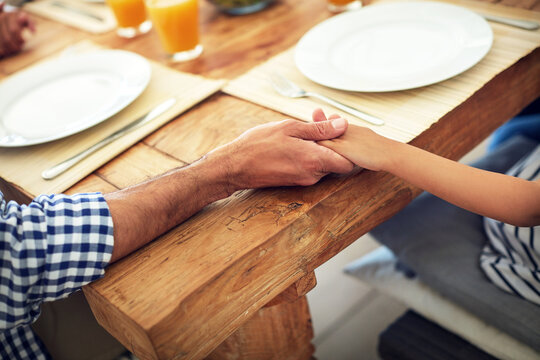 Family, lunch and holding hands with prayer for food, blessing or gratitude for nutrition. Grace, spiritual support and people with worship for meal, faith or celebration together for reunion in home