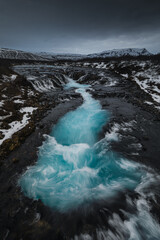 Obraz premium Bruarfoss waterfall in Iceland. Famous for its brilliant icy blue water swirling into a deep crevice. A hidden gem near the Golden Cir