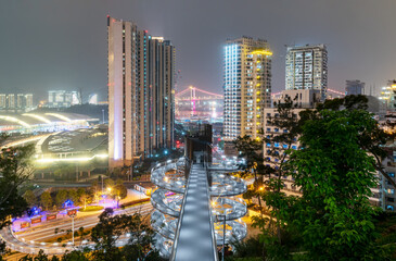 Fototapeta premium Xiamen Night Cityscape with Illuminated Buildings and Suspension Bridge