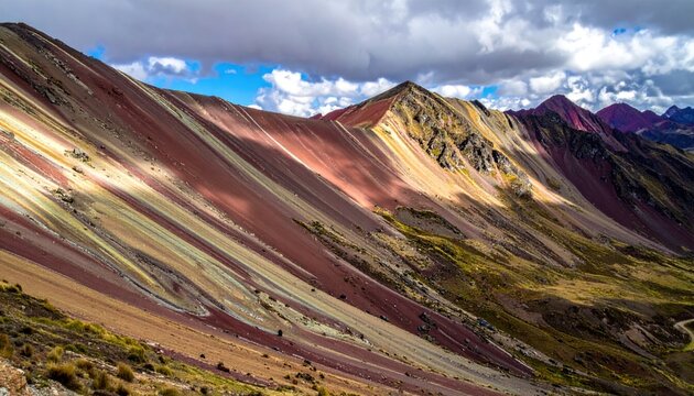 Striking Rainbow Mountain Landscape in Peru Under Cloudy Skies.