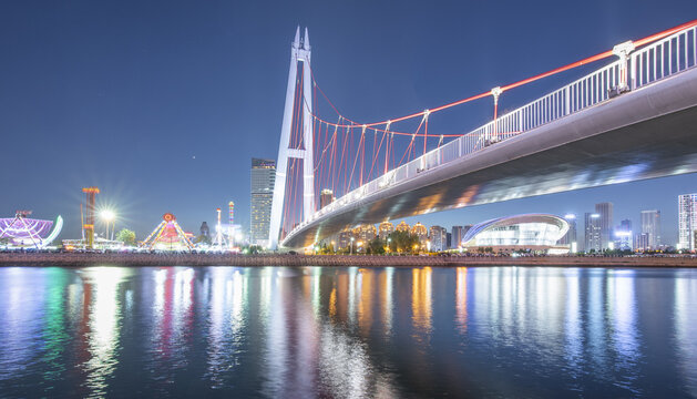 Dalian Star Bridge at Night Over Sea with City Lights