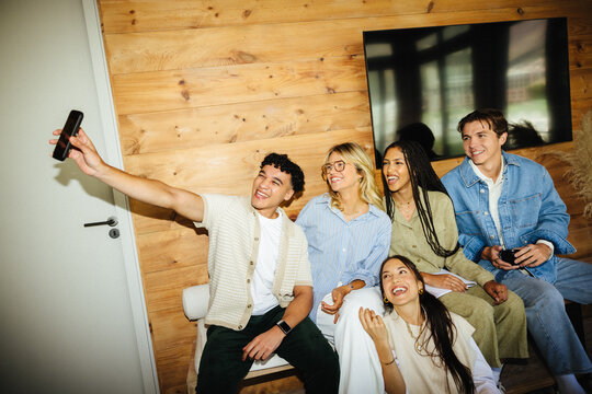 Diverse creative team enjoying a lighthearted selfie moment at work