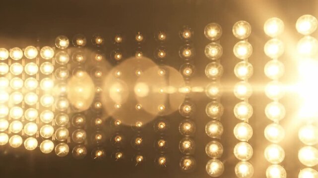 Array of glowing lights arranged in rows and columns against a dark background.