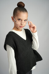 Young Girl in Glasses Looking Seriously Over Frames