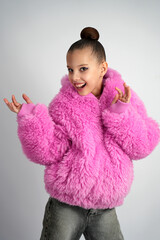 Playful Young Girl in Pink Faux Fur Jacket Expressing Joy