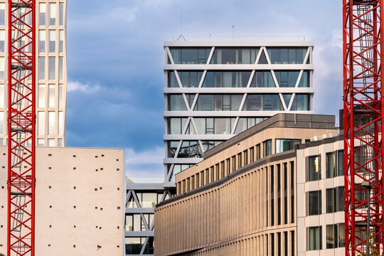 Blue sky in Berlin frames modern urban office architecture and framework between buildings as crane signals active construction growth