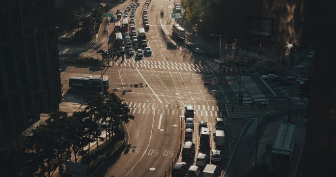 Aerial view of city traffic illustrating vehicles moving through intersections and crosswalks, highlighting the dynamic flow of urban transportation. Time-lapse, Seoul, South Korea