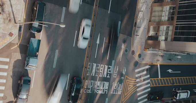 Aerial view of busy traffic illustrating vehicles navigating intersections, highlighting the movement and organization of urban transportation systems. Time-lapse, Seoul, South Korea