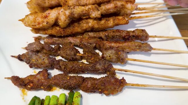 Close Up of Sichuan Grilled Lamb and Chicken Meat Skewers on Plate