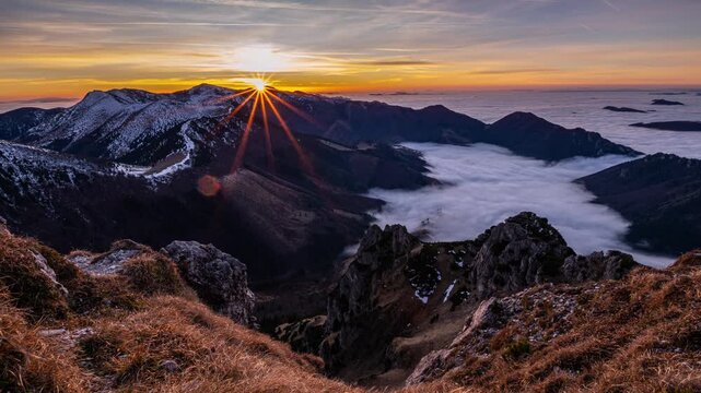 Beautiful Sunset Timelapse in Early Spring Alpine Mountains with Melting Snow and Foggy Clouds in Valley