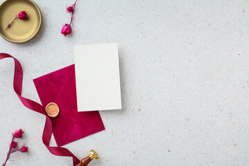 Wedding stationery set. Magenta envelope with a wax seal, blank card, and ribbon with copy space