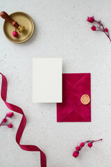 Vertical wedding stationery mockup with a closed magenta envelope and a blank paper card.