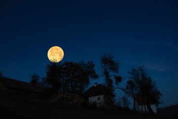 Fototapeta premium Full Moon, stars, planets and landscape scenery silhouettes.