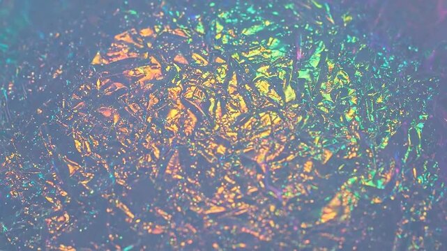 Abstract iridescent foil texture with vibrant colors, creating a mesmerizing and modern background.