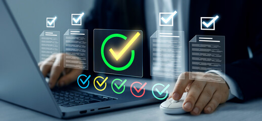 Business person checking digital documents on laptop with checklist approval icon, verification, workflow control, productivity and online document management.