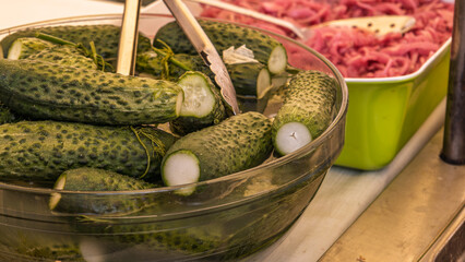 Fresh pickled cucumbers and red onions display