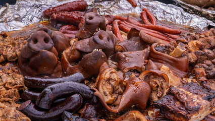Rustic platter of roasted pork and sausages