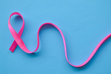 Red ribbon on blue background. International Womens Day Pink. 