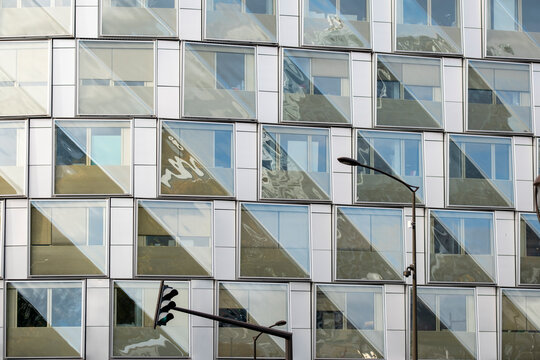 Modern urban office building windows facade grid in glass with abstract pattern creating clean architecture background for business and real estate