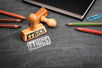 Fototapeta na wymiar Ethics Concept With Wooden Stamp On Blackboard Workspace