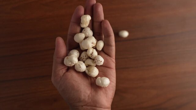 Picking Makhana with a human hand.