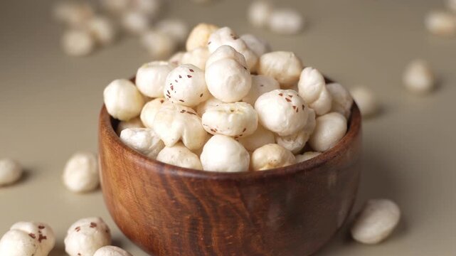 Makhana on wooden bowl closeup shot in panning motion.