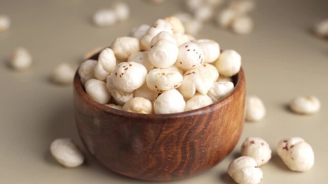 Makhana on wooden bowl closeup shot in panning motion.