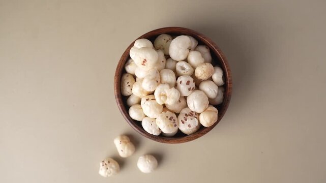 Makhana on wooden bowl closeup shot in zoomin motion.