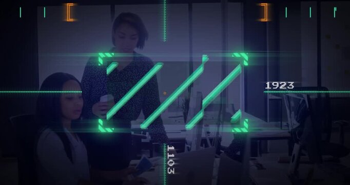 Digital interface elements over businesswomen working in modern office