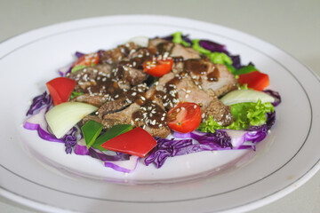 Grilled Beef Teriyaki Salad with Fresh Vegetables and Sesame Seeds