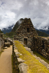 Machu Picchu Inca ruin in clouds.