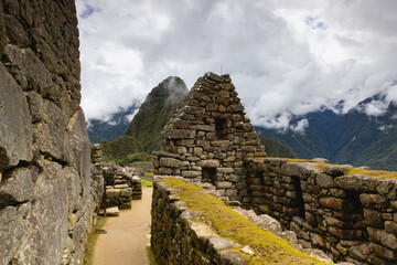 Machu Picchu Inca ruin in clouds,