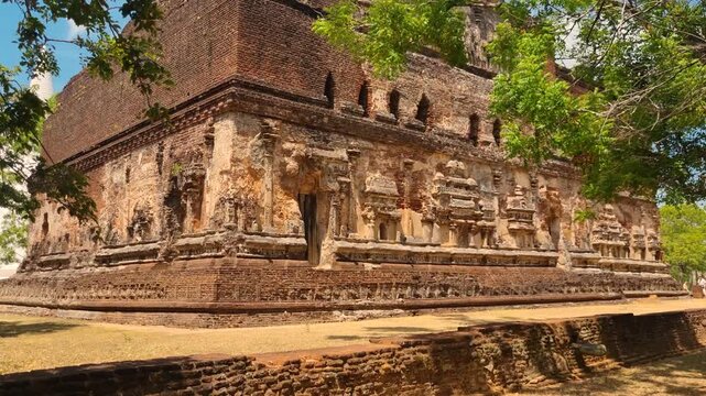Facade view of Lankatilaka Gedige Shrine in Polonnaruwa, Sri Lanka, a 12th-century brick Buddha temple built by King Parakramabahu I, part of the UNESCO Cultural Triangle, on a sunny day