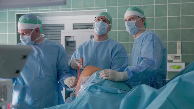 Three surgeons in full sterile attire conduct a knee arthroscopy procedure in a modern operating room, focusing on collaboration and precision