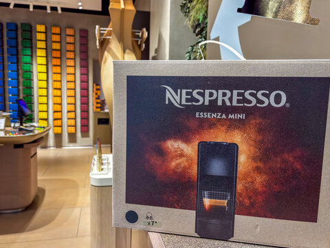 Bratislava, Slovakia, Europe - Jan 27, 2026: Nespresso essenza mini box coffee machine packaging cardboard store interior background display of espresso pods in retail boutique shop atmosphere