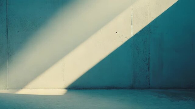 Diagonal sunlight creating a strong contrast of bright light and cool blue shadows on a textured concrete wall and floor, emphasizing an empty minimalist space