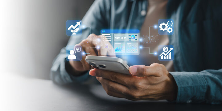 Businessman using smartphone virtual AI CRM HUB dashboard interface for mobile business management and sales analysis, Efficiency Growth, Business on the go, Digital marketing, Customer engagement