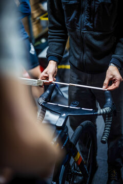Mechanic measuring bicycle handlebars for bike fitting setup