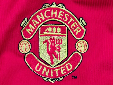 Photo of the Manchester United FC emblem, the official crest of the professional English football club based in Manchester.
