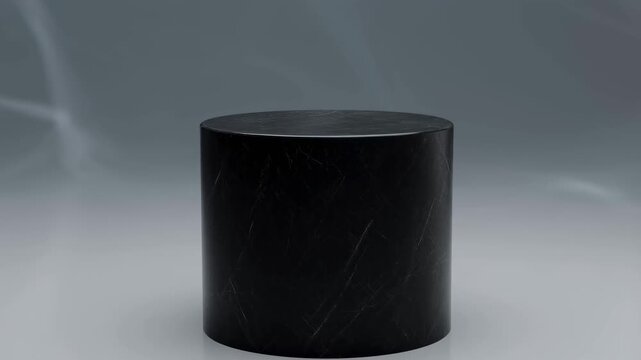 Elegant black marble pedestal rotating against a soft gray background. Ideal for showcasing products or artistic displays in a modern setting