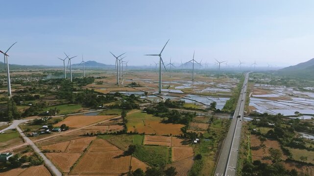Aerial 4K Wind Turbine Farm Beside Modern Cam Lam - Vinh Hao Expressway, Vietnam
a massive wind farm with rotating turbines situated along the newly completed Cam Lam - Vinh Hao Expressway in Vietnam