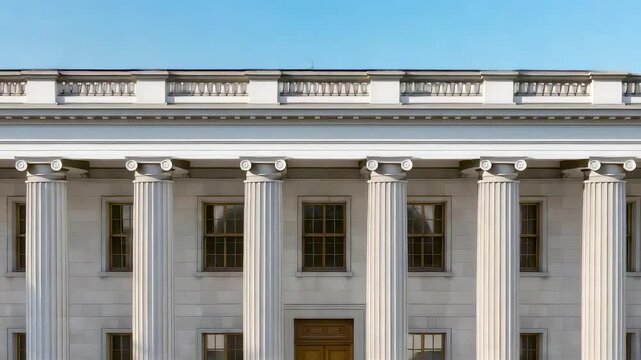 Classic white marble building with tall ionic columns grand entrance pediment blue sky neoclassical architecture historic facade government landmark