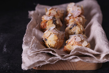 Italian amaretti cookies on a dark background. Italian cookies with almonds. The cookies are round.