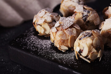 Italian amaretti cookies on a dark background. Italian cookies with almonds. The cookies are round.