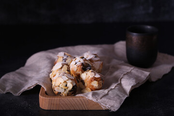 Italian amaretti cookies on a dark background. Italian cookies with almonds. The cookies are round.