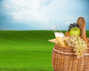 Obraz premium Beautiful cute picnic set on green grass in park