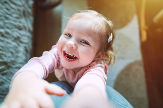Little adorable cute infant girl at the age of 1.5 years is laughing. Childhood and family concept. High quality photo.