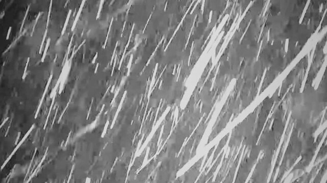 A blizzard captured on the screen of a CCTV system showing the brightly lit view of an external camera.