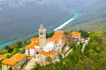 Aerial view of the Basilica of the Assumption of Mary on the Holy Mountain (Sveta Gora) and the Soca river Canyon in Slovenia at autumn time