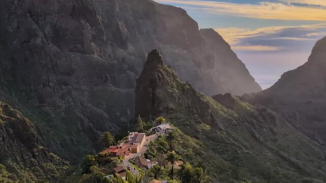 Landscape of the Masca valley in Tenerife, Canary island, Spain. Scenic mountain landscape with palm trees and tropical vegetation in Tenerife. Famous volcanic rock formation in Masca village